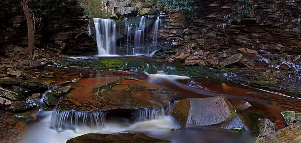 Photo of Waterfalls, tannin colored stream and rocks