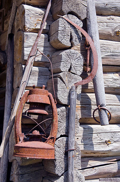 istock rusty sickle and kerosene lamp on old farm wall 178800517