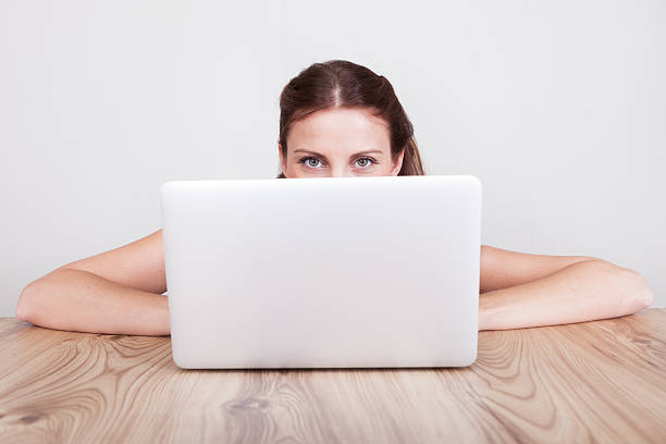 istock Woman hiding behind her laptop 178800791