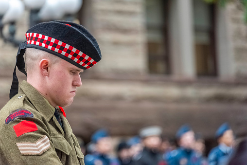 Toronto Ontario, Canada- November 11th, 2023: A head shot of a man standing guarding at the cenotaph during the Remembrance Day ceremony at Old City Hall in downtown Toronto.