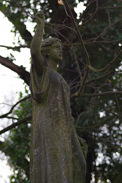 Weeping Angel in dilapidated Graveyard stock photo