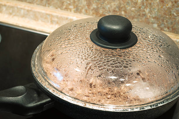 istock cooking in frying pan with cover on stove 178803479