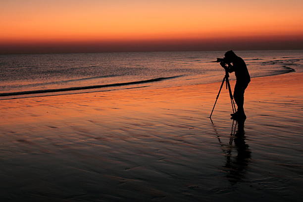 istock Silhouette of photographer clicking sunset 178803651