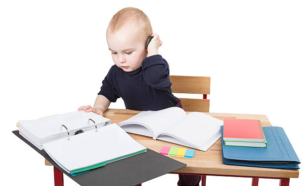 young child at writing desk stock photo