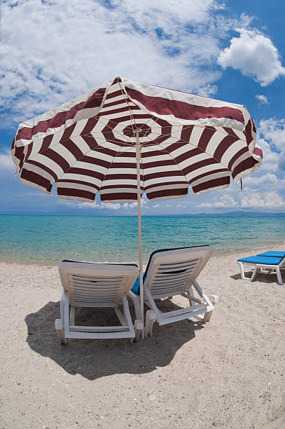 summer beach and row of umbrellas - Corfu - Greece