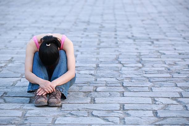istock woman sit at xian city wall 178804356