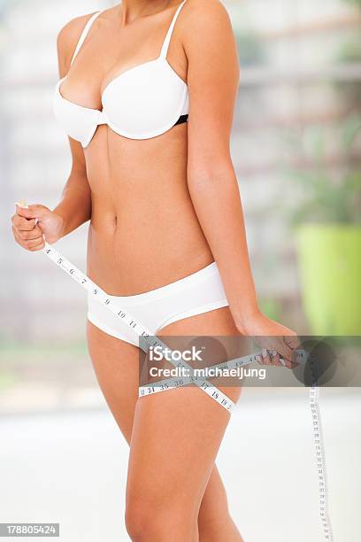 Woman Measuring Her Thigh Stock Photo - Download Image Now - Abdomen, Adulation, Adult