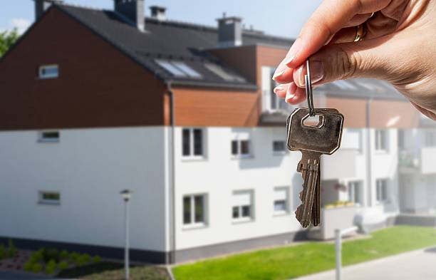 istock Woman's hand holding keys to new house 178805446