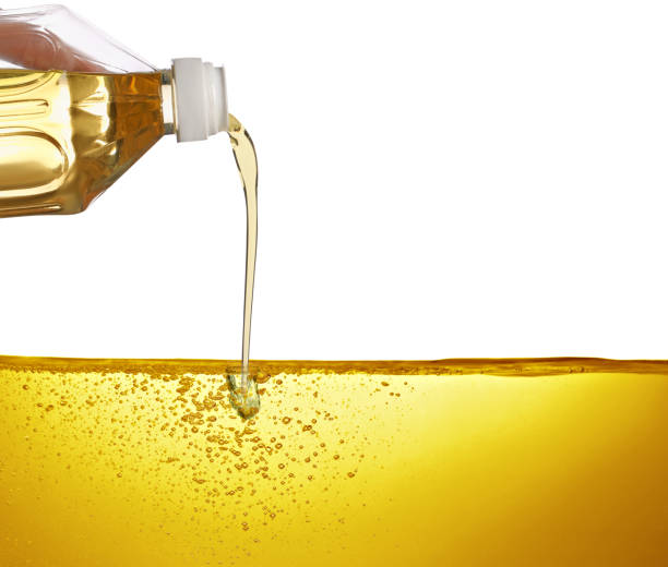istock Pouring cooking oil from bottle against white background 1788061376