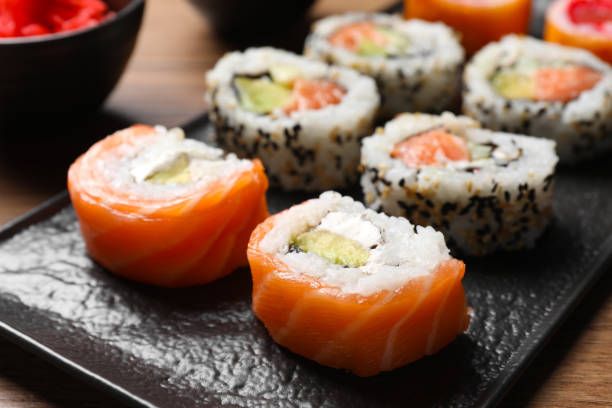 istock Delicious sushi rolls on black plate, closeup 1788064014