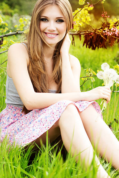 Beautiful girl with dandelions. Nature