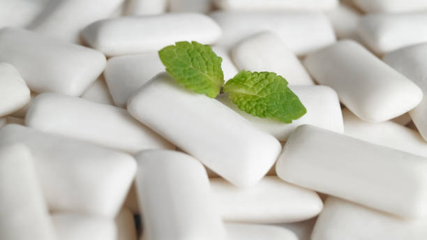 istock Tasty chewing gums and fresh mint leaves as background, closeup 1788064573