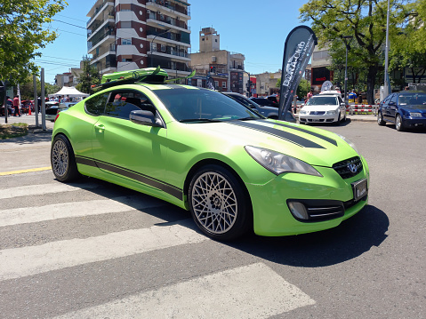 Buenos Aires, Argentina - Nov 6, 2022: Green 2011 Hyundai Genesis 3.8 sport coupe in the street. Classic car show. Sunny day.