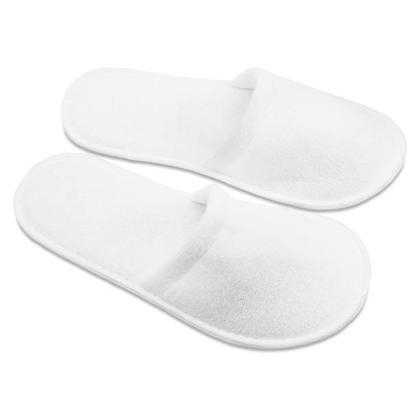 istock A pair of white disposable textile slippers on a white background. 1788070832
