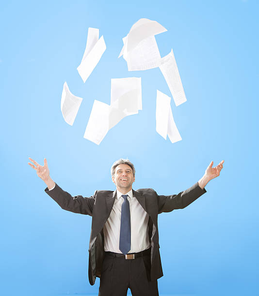 istock Senior businessman throwing sheets of paper 178807383