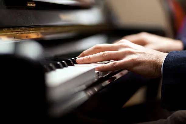 Closeup of a man playing piano