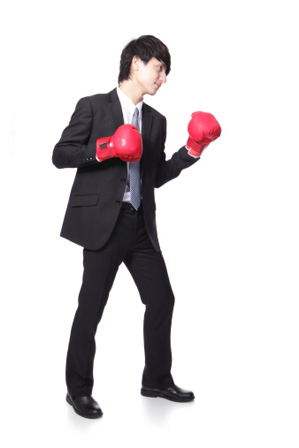 Asian businessman battle with boxing glove, full body