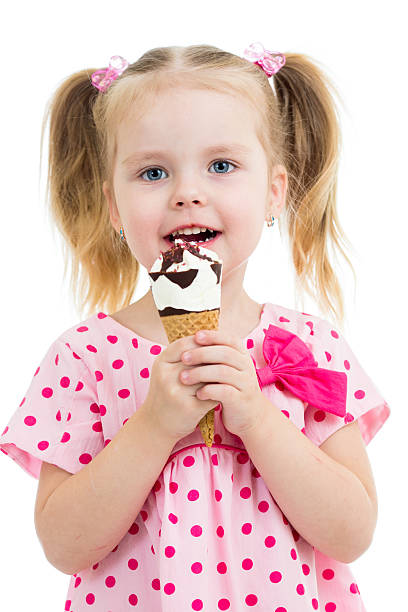 istock joyful child girl eating ice cream in studio 178807895
