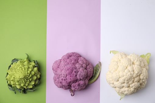 Different fresh cabbages on colorful background, flat lay. Space for text
