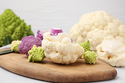 Various cauliflower cabbages on light grey table