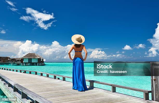 Woman On A Beach Jetty At Maldives Stock Photo - Download Image Now - Adult, Beach, Blue