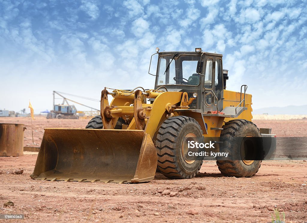 Bulldozer loading machine in the middle of a job Bulldozer loader machine during earthmoving works outdoors Construction Equipment Stock Photo