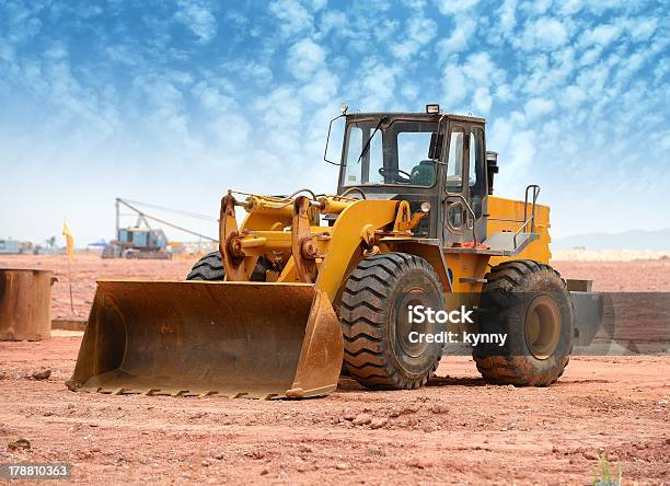 Bulldozer Loading Machine In The Middle Of A Job Stock Photo - Download Image Now - Construction Equipment, Backhoe, Bulldozer