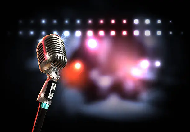 Photo of A retro style microphone with a blurred lights background