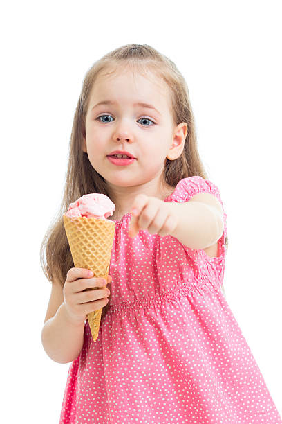 istock joyful child girl eating ice cream in studio 178811072