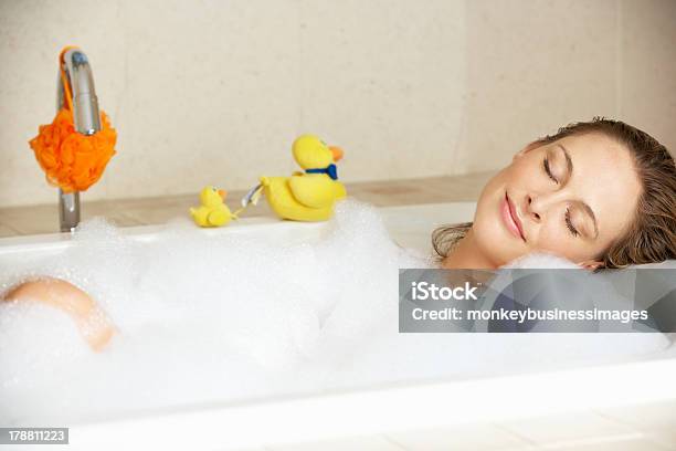 Attractive Woman Relaxing In A Bubble Filled Bath Stock Photo - Download Image Now - Women, Bathtub, One Woman Only