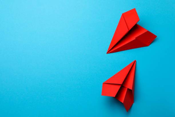 istock Handmade red paper planes on light blue background, flat lay. Space for text 1788118182