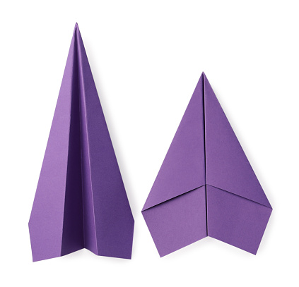 Handmade purple paper planes isolated on white, top view