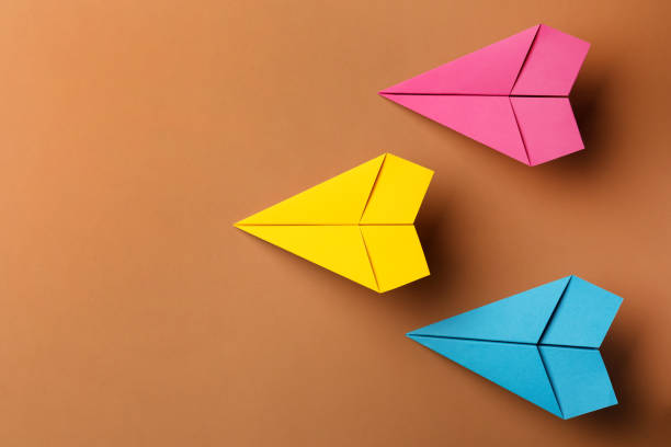 istock Handmade colorful paper planes on brown background, flat lay. Space for text 1788119265
