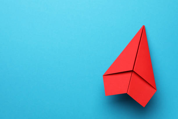 istock Handmade red paper plane on light blue background, top view. Space for text 1788120361