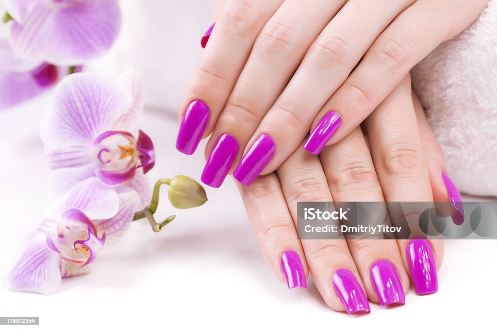 beautyful manicure with fragrant orchid and towel. Spa manicure with fragrant orchid and towel Alternative Therapy Stock Photo