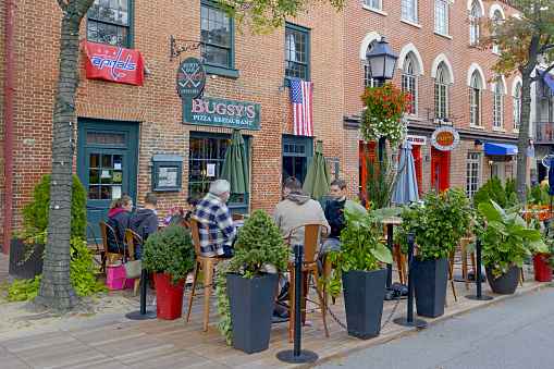 People outside Bugsy's Pizza restaurant on King Street in Old Town Alexandria VA