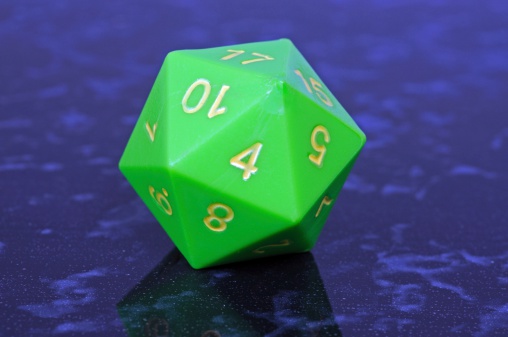 Green icosahedron 20 sided shaped numbered die against a blue background.