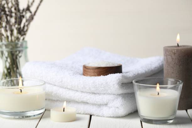 istock Beautiful composition with burning candles and different spa products on white wooden table 1788133125