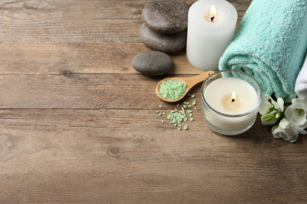 istock Beautiful composition with burning candles and different spa products on wooden table. Space for text 1788134751