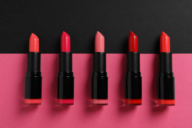 istock Beautiful lipsticks on black and pink background, flat lay 1788145346