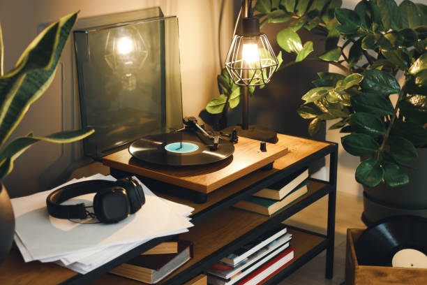 istock Stylish turntable with vinyl record on table in cozy room 1788146974