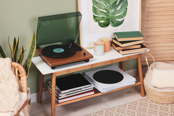 istock Stylish turntable with vinyl record on console table in cozy room 1788147487