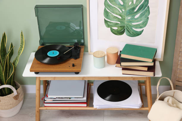 istock Stylish turntable with vinyl record on console table in cozy room 1788147492