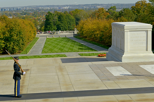 A lone soldier stands guard over the Tomb of the Unknown Soldier at Arlington Cemetery in Virginia