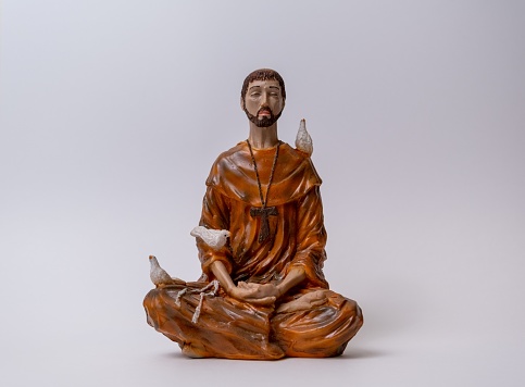 A statuette of Saint Francis of Assisi meditating in the lotus position