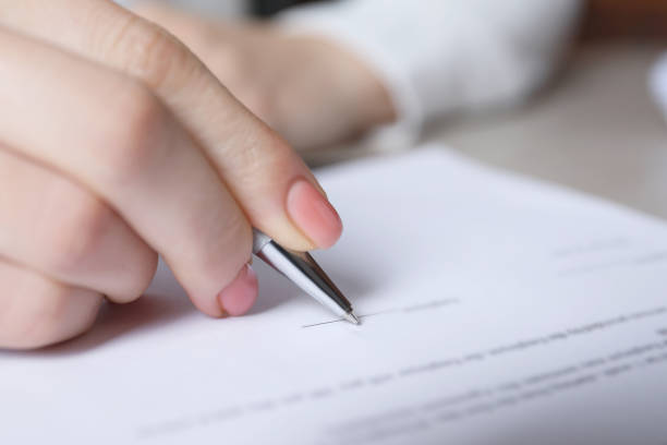 istock Woman signing document at table in office, closeup 1788177697