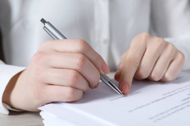 istock Woman signing document at table in office, closeup 1788177987