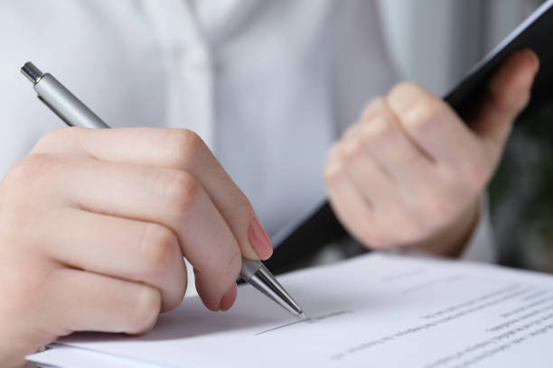 istock Woman signing document at table in office, closeup 1788177991