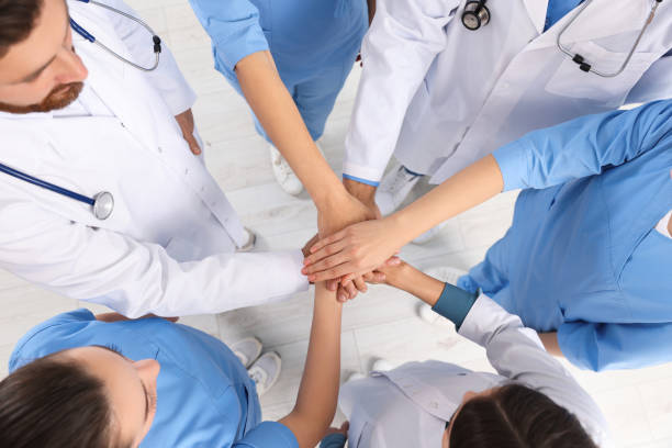 istock Team of medical doctors putting hands together indoors, above view 1788198697