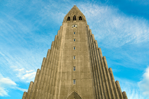 Reykjavík, Capital Region, Iceland: Hallgrímskirkja (Hallgrím Church)  - an Evangelical Lutheran parish church of the  Evangelical Lutheran Church of Iceland (State Church of Iceland), the largest church building in Iceland and the second tallest building in the country after the Smáratorg Tower - built in 1945-1986 and named after Rev. Hallgrím Pétursson hymn poet.  The building was designed by the state architect Guðjón Samúelsson. The external appearance is dominated by the Expressionist style, similar to the Grundtvig's Church in Copenhagen (1940). The concrete pillars are inspired by basalt columns, a common motif in the Icelandic landscape.